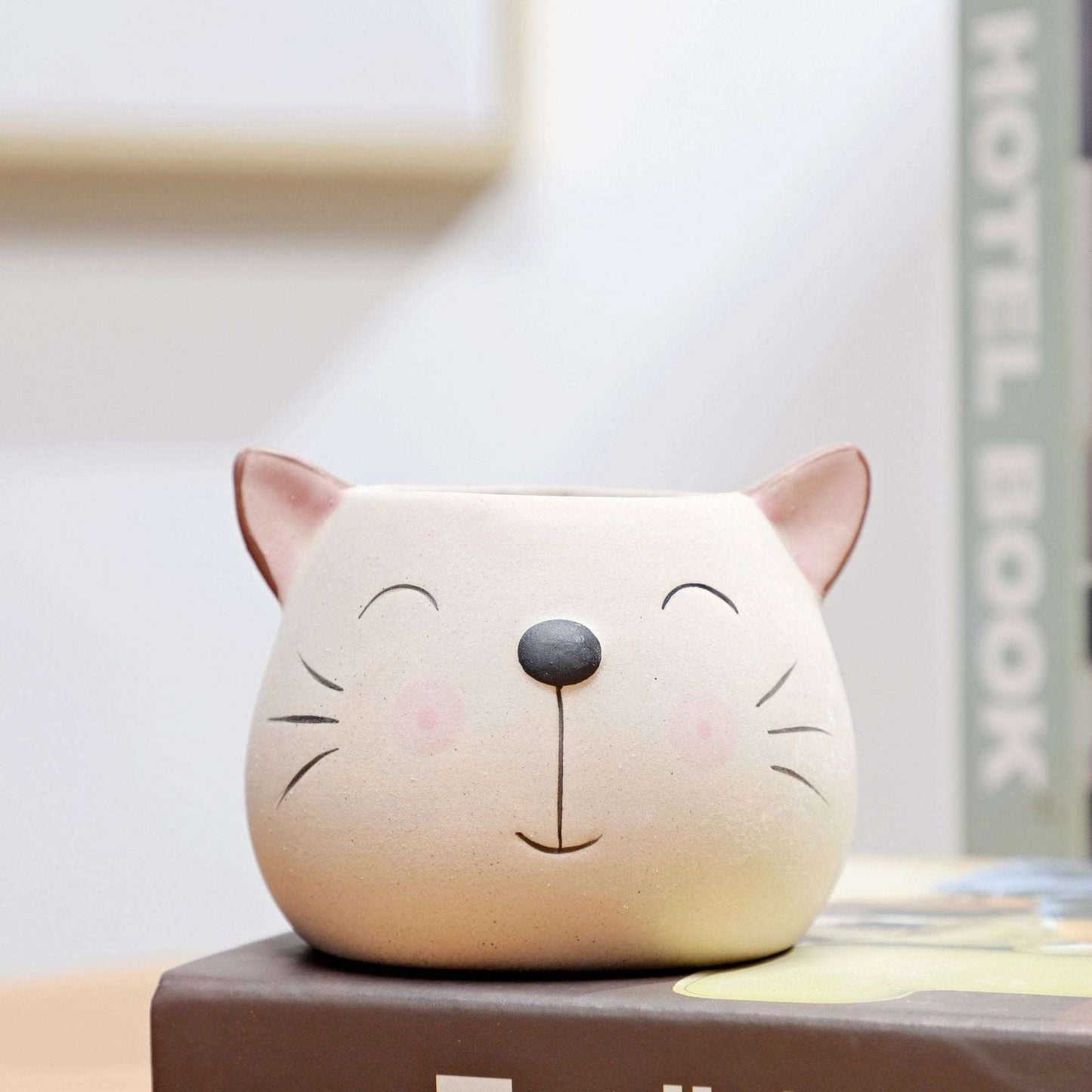 a white teddy bear sitting on top of a box
