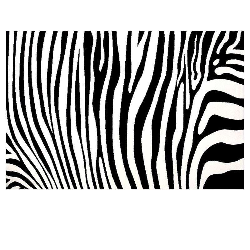 a black and white photo of a zebra