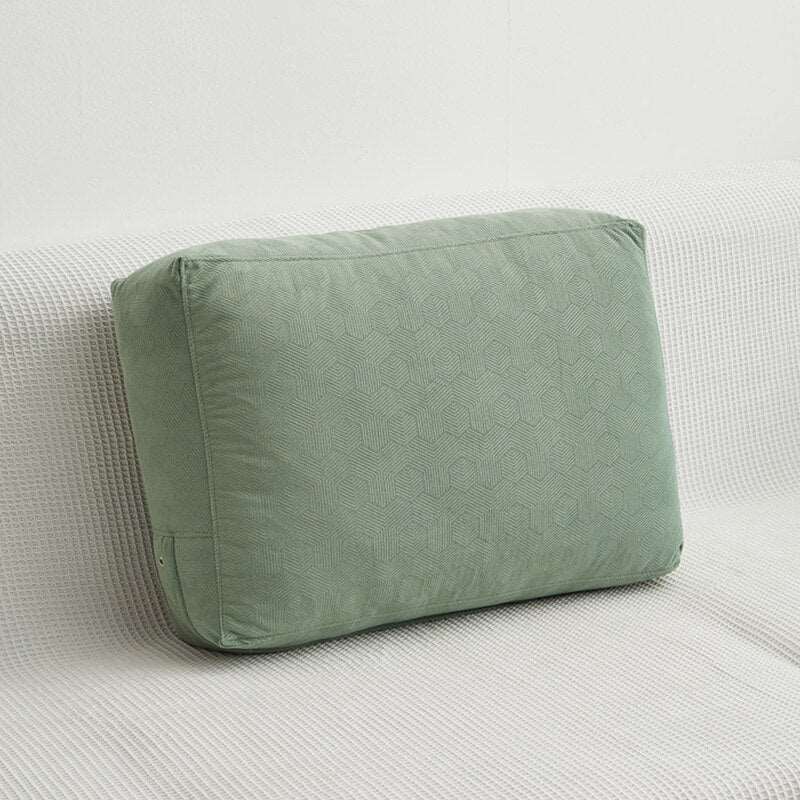 a green suitcase sitting on a white surface