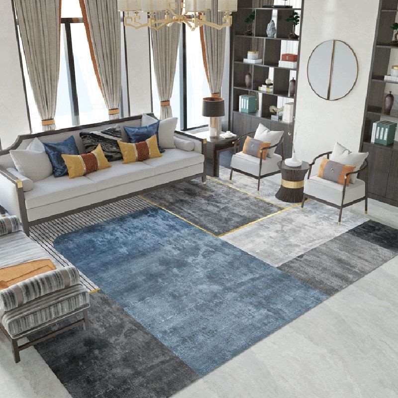 a living room filled with furniture and a rug