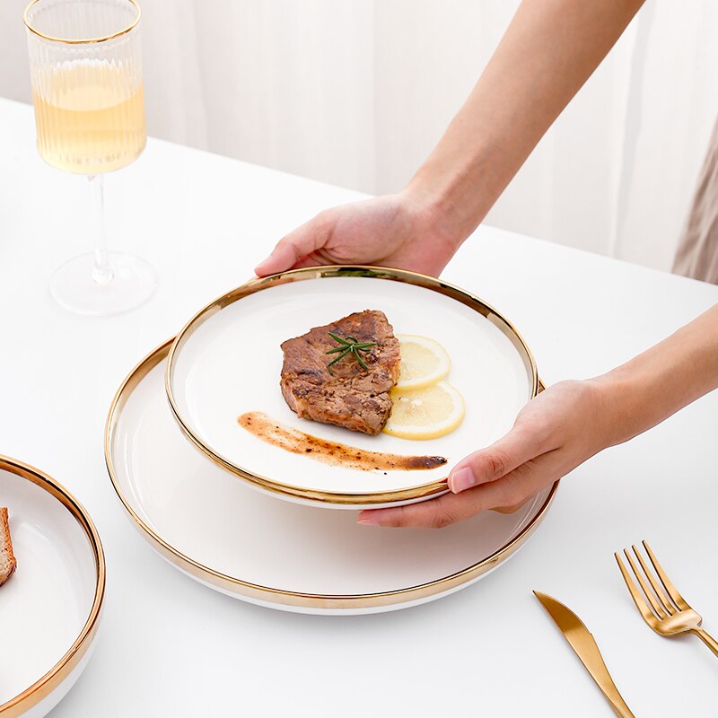 a person holding a plate with a piece of cake on it