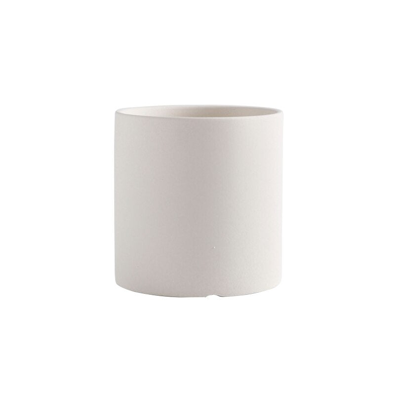 a white cup sitting on top of a table
