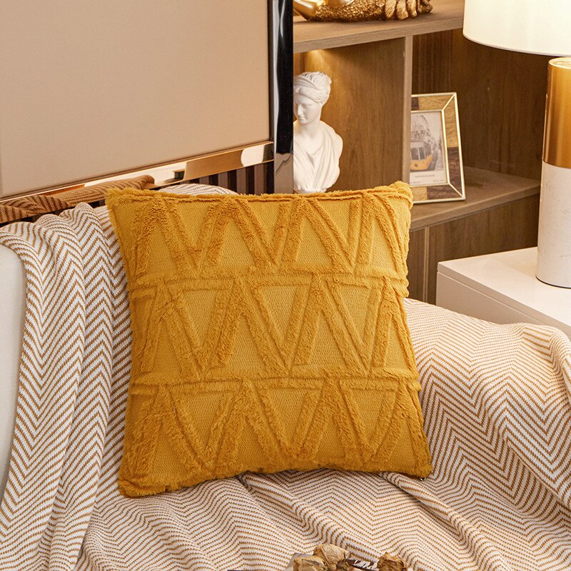 a bed with a white and orange blanket