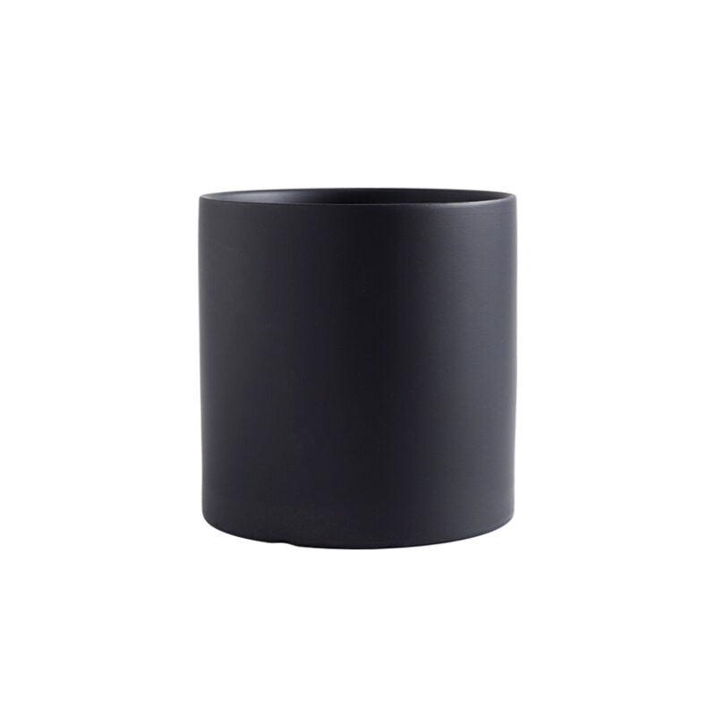 a black coffee cup sitting on a table