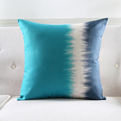 a blue vase sitting on top of a couch