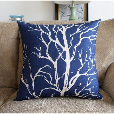 a blue and black vase sitting on top of a couch