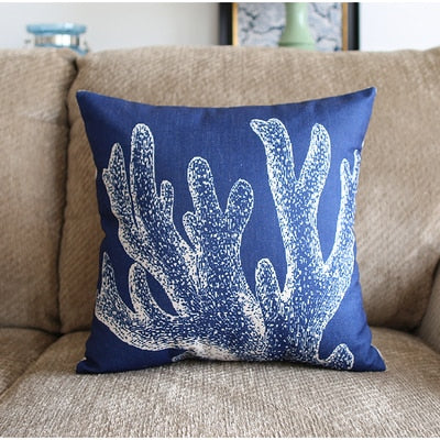 a blue pillow sitting on top of a couch