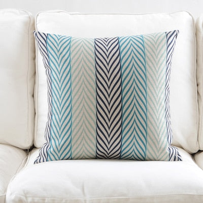 a neatly made bed with a blue and white comforter