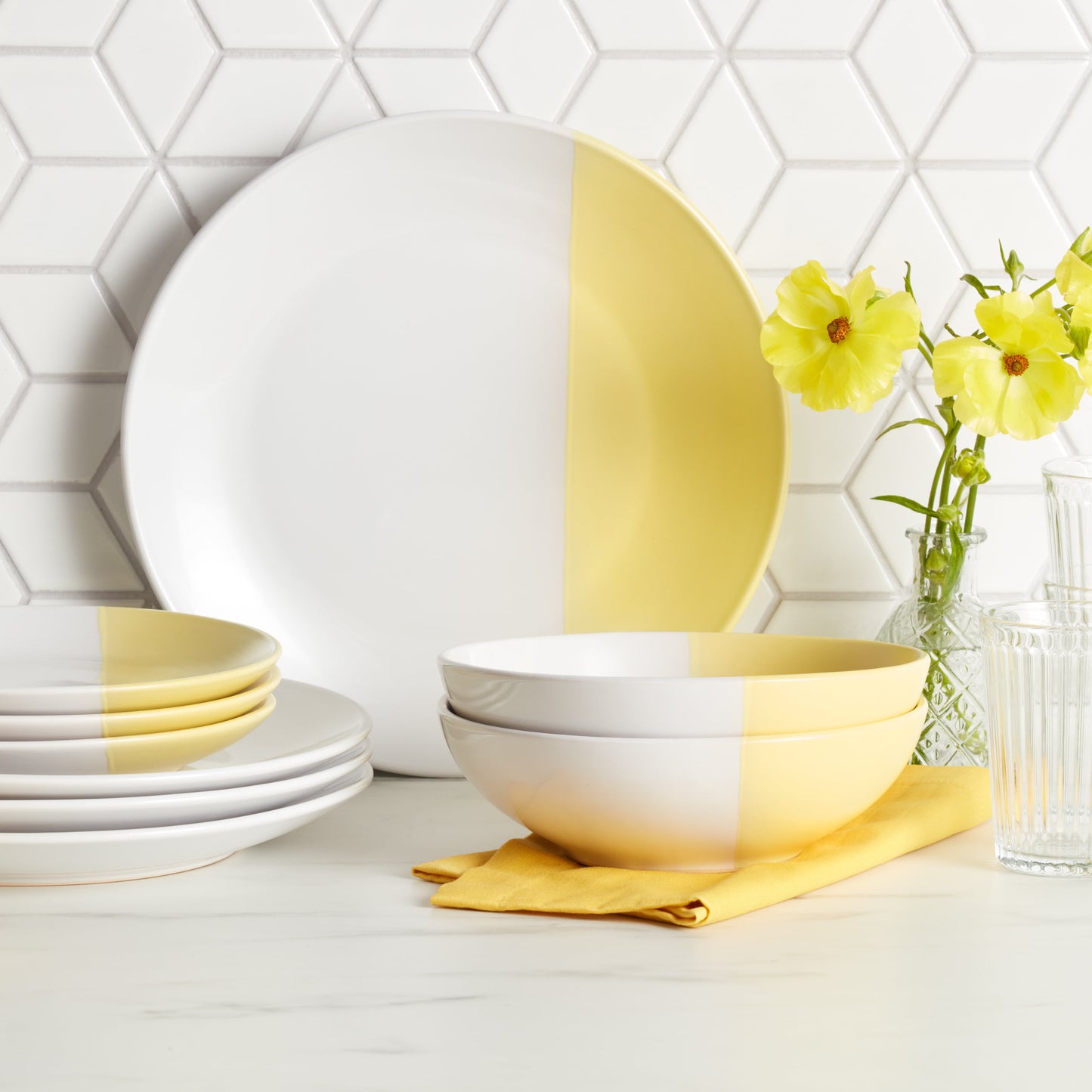 a bowl of yellow flowers sitting on a table