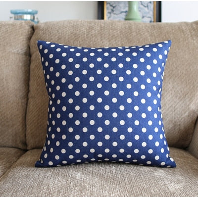 a blue and white polka dot tie sitting on top of a couch