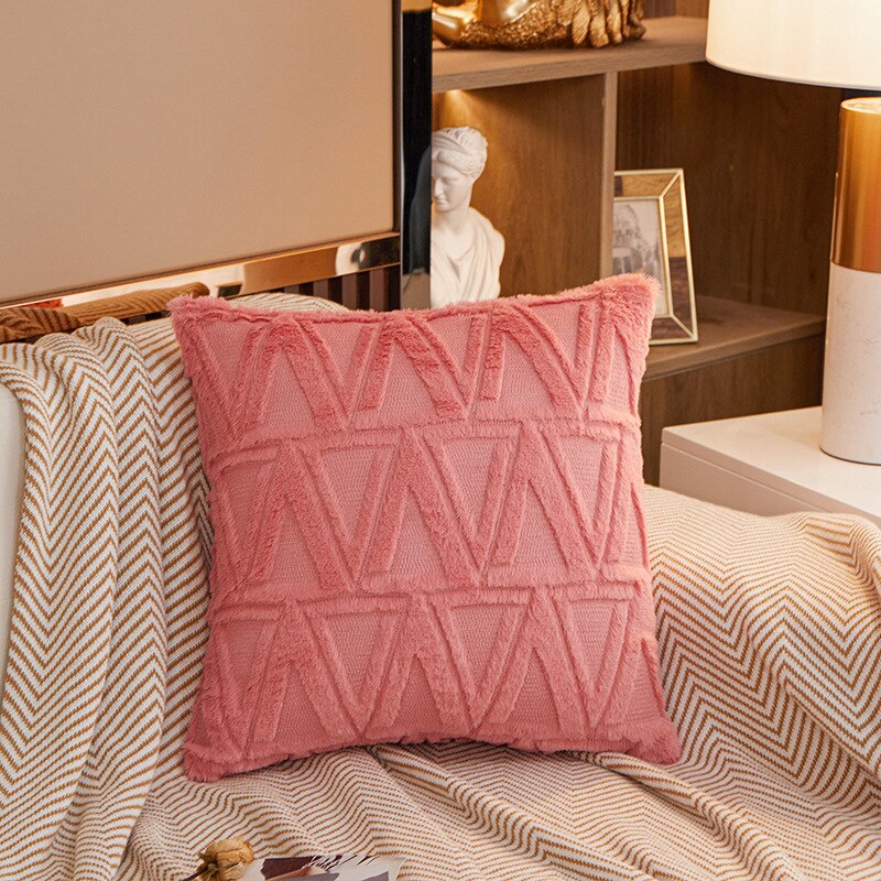 a bed with a red blanket and pillows