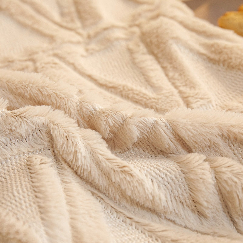 a herd of sheep laying on top of a blanket