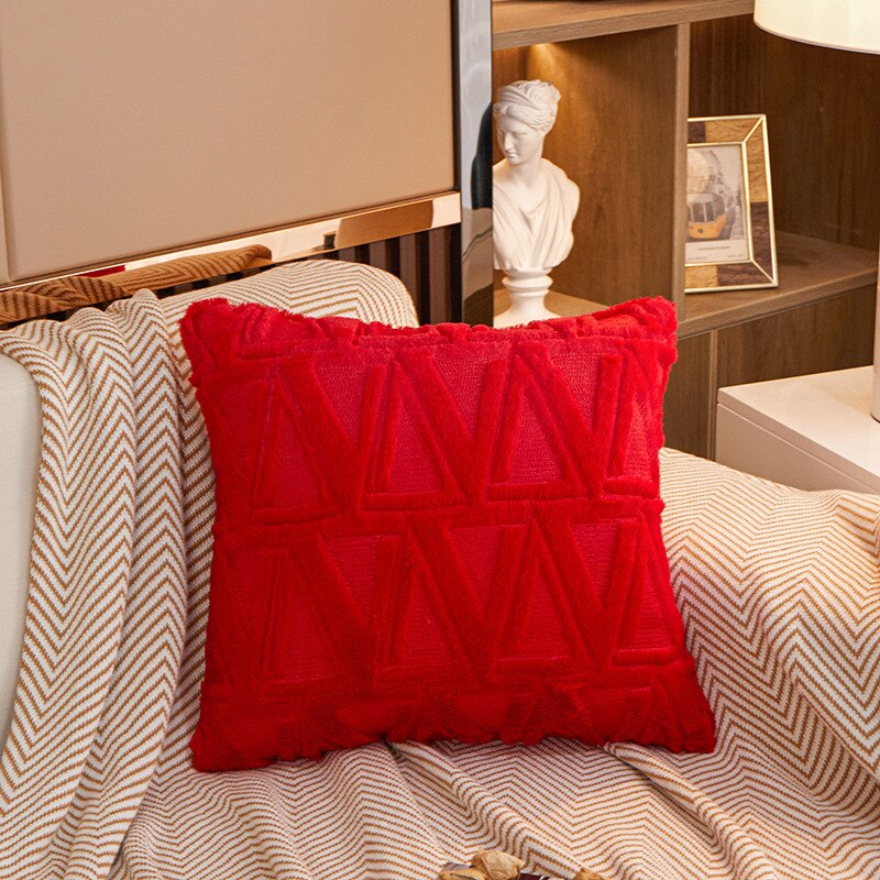 a bed with red pillows and a red blanket
