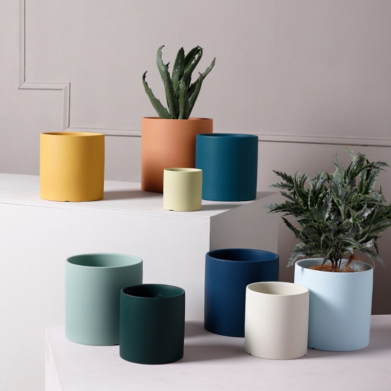 a set of three vases sitting on a table