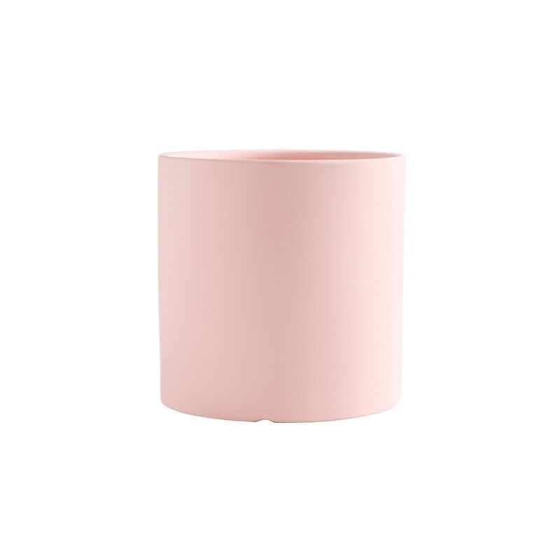 a pink cup is sitting on a table 