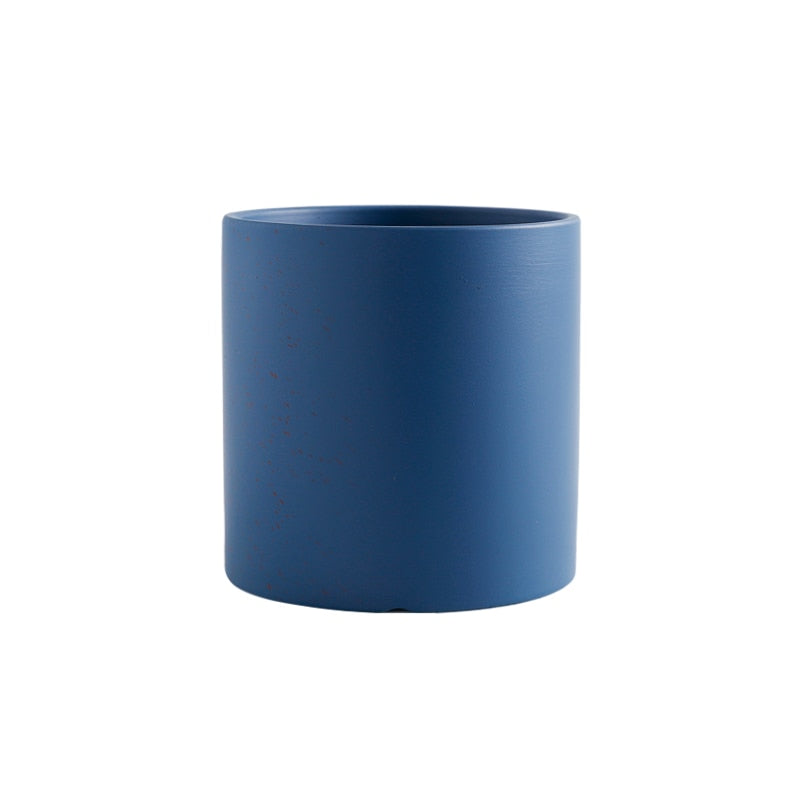 a blue vase is sitting on a table 