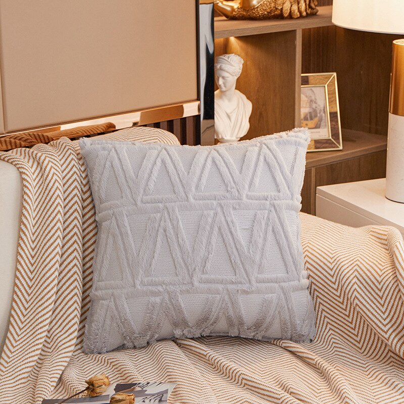 a bed with white sheets and pillows in a room 