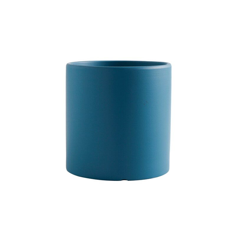 a blue vase is sitting on a table 